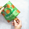 Hand pulling a macaroon from the Choomi package