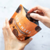 Hand pulling a brownie from the Choomi package