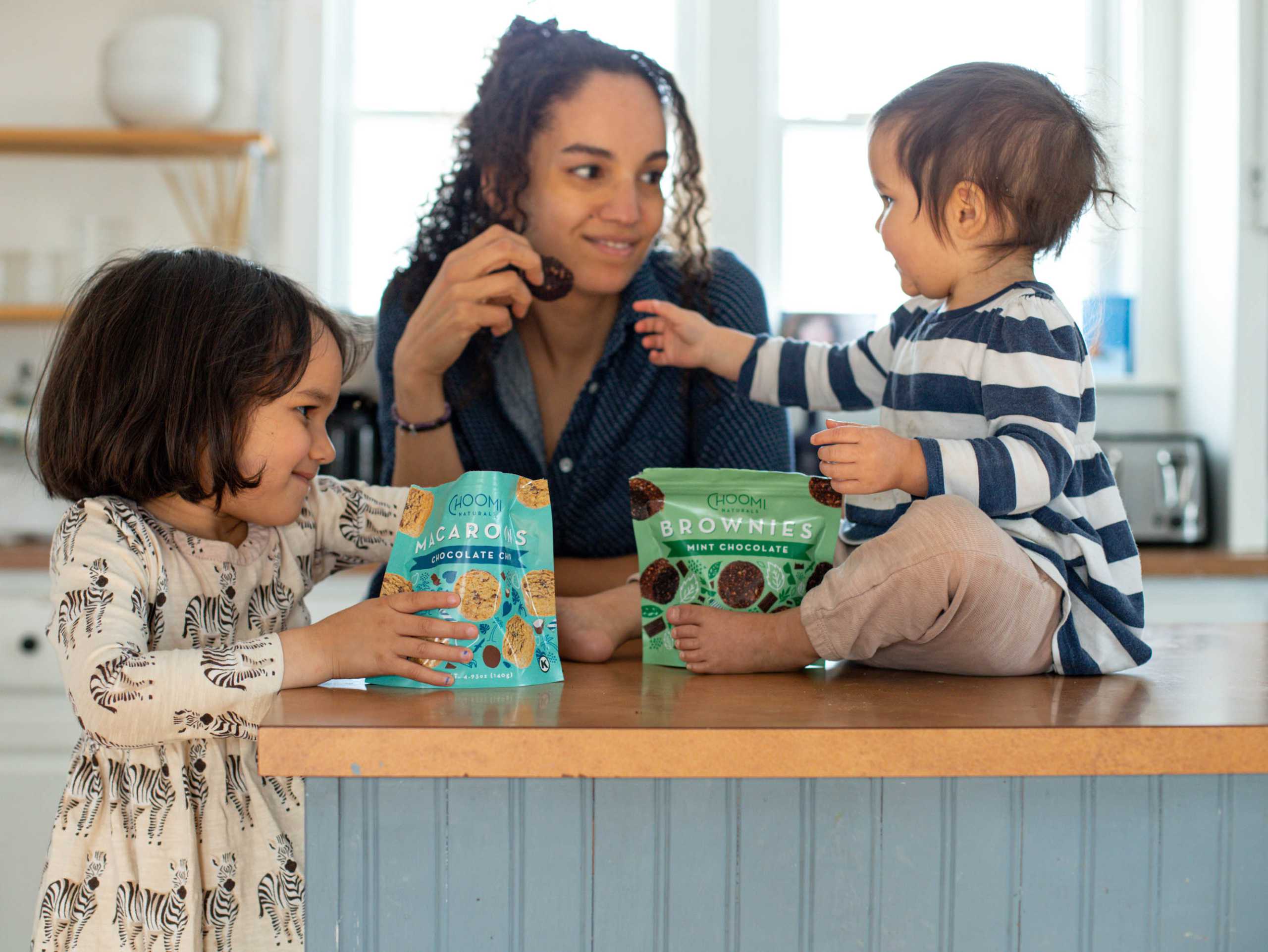 Kids and adult enjoying Choomi Macaroons and Brownies at snack time